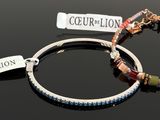 two bracelets that are sitting on a table