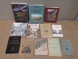 several books are sitting on a table in front of a wall