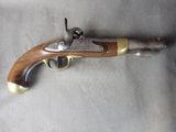 an old gun with a wooden handle on a gray surface
