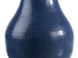 a blue vase that is sitting on a white surface