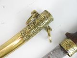 a very old looking dagger on a white surface