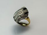 a close up of a ring with diamonds on a white surface