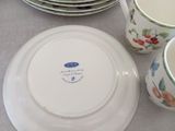 many plates and cups sitting on a table