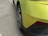 a yellow car parked on the side of the street