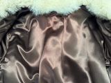 a close up of a jacket with a fur collar