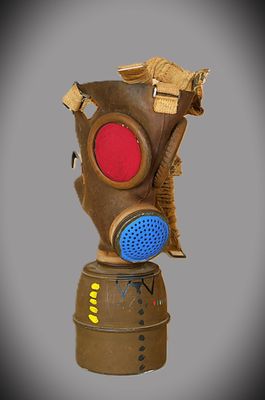 a brown gas mask with a red and blue face
