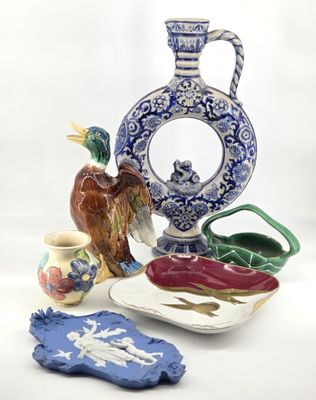 a blue and white vase with a bird on it and a plate with a bird on it