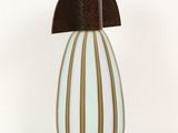 a white and brown vase with a brown top on a white background