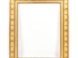an antique gold frame with a decorative pattern and a white background