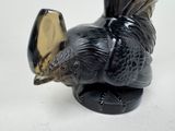 a black and gold turkey figurine sitting on a white surface