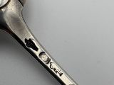 a spoon with a spoon handle that has a bird on it