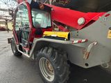 an image of a red tractor parked in a warehouse