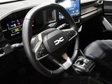 the interior of a car with a steering wheel and dashboard controls