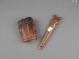 an old wooden pipe with a wooden handle next to it