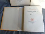 three books sitting on top of a bed next to each other