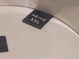 a close up of a toilet seat with a label on it