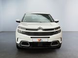 the front view of a white citrole parked in a room