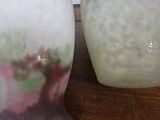 two vases that are sitting on a table