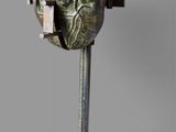 a metal sculpture of a human heart on a stand
