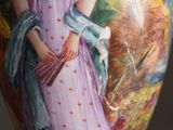 a vase with a picture of a woman in a purple dress