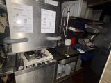 a kitchen with a stove, sink, and refrigerator in it