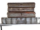three suitcases stacked on top of each other on a table