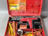a red tool box with tools in it on a table