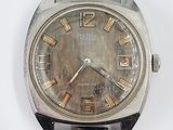 wrist watch with silver face and brown leather strap on white surface