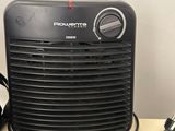 a black heater sitting on a table next to a toaster and a toaster