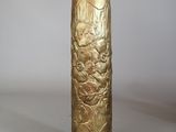 a gold vase that is sitting on a table