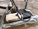 a small machine that is sitting in the mud