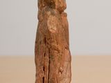 a small statue of a woman sitting on a wooden table