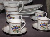 several cups and saucers are sitting on a table with a bowl and saucer in the background