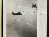 a black and white photo of a plane flying in the sky