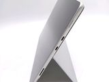 underside view of a silver laptop computer sitting on top of a white surface