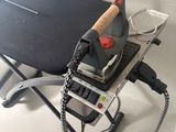a small ironing board on a desk with a computer on it