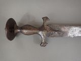 a knife that is hanging on the wall in the room