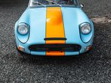 a blue and orange sports car parked in a parking lot