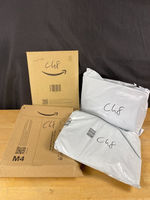 a couple of bags sitting on top of a table next to a cardboard box