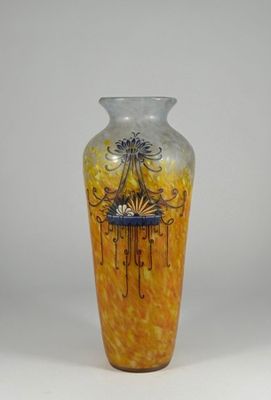 a yellow vase with a design on it on a white background