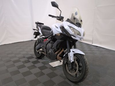 a motorcycle that is parked in a room with a checkered floor