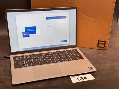 an open laptop computer sitting on top of a table next to a cardboard box