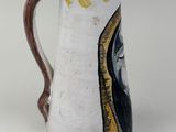 a white and yellow vase with a black and yellow design