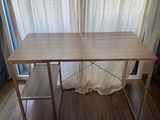 a wooden table with a metal frame on it