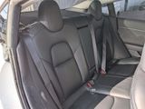 the back seats of a car are black and grey in color