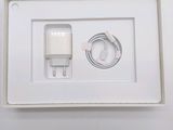 a white box with a charger and a cable in it