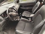 the interior of a car with a steering wheel and a dashboard