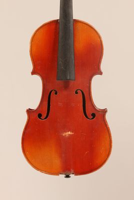 an old violin with a bow hanging from the back