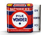 a tin of pill wonder next to a box of cigarettes