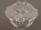 a glass vase with roses in it on a table